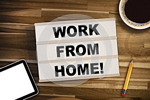 Lightbox or light box with message Homeoffice Work From Home on a wooden table with cup of coffee
