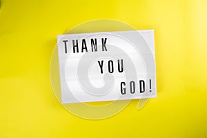 Lightbox with message THANK YOU GOD on yellow background, pleased gratefulness