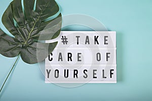 Lightbox with motivational words for self-care, mental health, emotional well-being. Top view