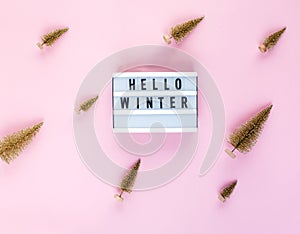 Lightbox on pastel pink background. Christmas, New Year concept flat lay.