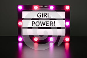 Lightbox with pink lights in dark room with words - girl power