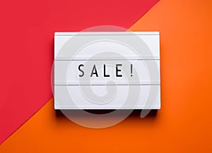 lightbox on which the sale is written on an orange
