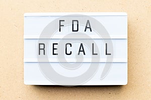 Lightbox with word fda recall on wood background