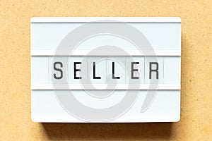 Light box with word seller on wood background