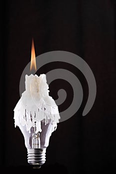 Lightbulb and burning candle