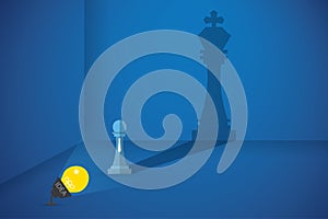 Lightbulb flash the pawn chess to shows big shadow of king chess, idea and business concept01