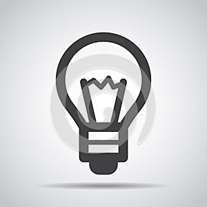 Lightbulb icon with shadow on a gray background. Vector illustration