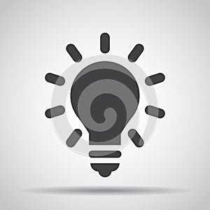 Lightbulb icon with shadow on a gray background. Vector illustration