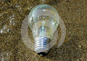Lightbulb or idea who has survived in water, a bit light left in the bulb photo