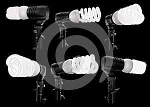 Lightbulb in lamp holder on studio stand isolated on black background