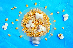 Lightbulb made from sweet corn kernels on blue