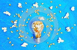 Lightbulb with popcorn kernels on blue
