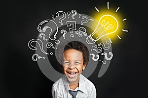 Lightbulb, question marks and smart laughing child. Brainstorming and idea concept