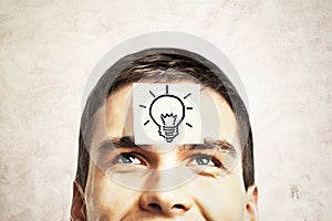 Lightbulb sketch on guy's forehead