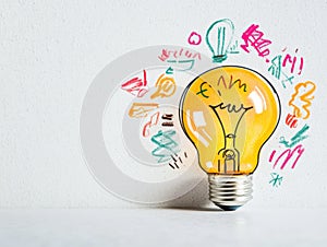 Lightbulb with colorful doodles representing creative ideas