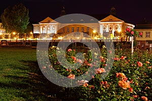 Lighted baroque building with rose garden romantic night scene in German spa town