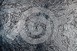 Lighted black textured wall as a background