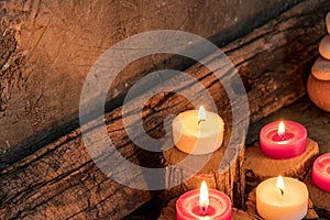 Lighted candles with ornate wood and scented and energetic incense