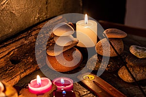 Lighted candles with ornate wood and scented and energetic incense