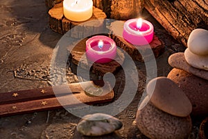 Lighted candles with ornate wood and scented and energetic incense photo