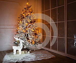 A lighted Christmas tree with presents underneath