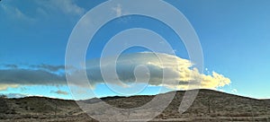 Lighted Clouds Against a Blue Sky over the Hills of the Tejon Pass