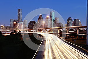 Lighted Houston skyline against blue sky photo