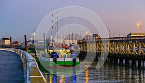 Lighted ship in the harbor of Blankenberge at sunset, Belgian architecture of a popular town in Belgium