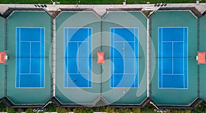 Lighted tennis courts grouped together photo