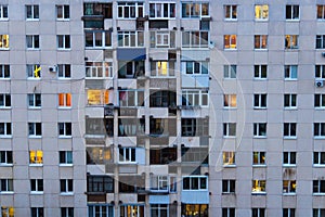 Lighted windows and balconies of an old night residential building