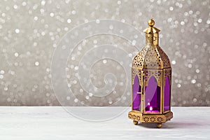 Lightened lantern on wooden table over bokeh background. Ramadan kareem holiday celebration