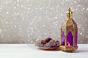 Lightened lantern on wooden table over bokeh background. Ramadan kareem holiday celebration