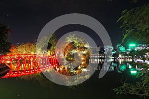 Lightened red bridge over Hoan Kiem lake, Hanoi, Vietnam