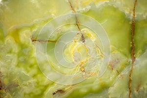 Lightened slices marble onyx. Horizontal image. Warm green colors. Beautiful close up background