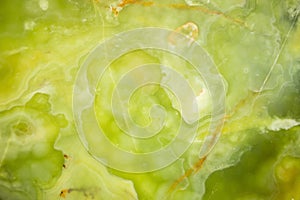 Lightened slices marble onyx. Horizontal image. Warm green colors. Beautiful close up background