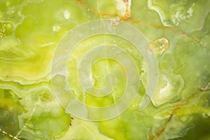 Lightened slices marble onyx. Horizontal image. Warm green colors. Beautiful close up background