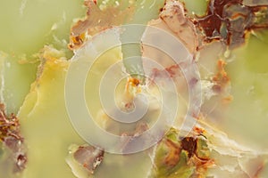 Lightened slices marble onyx. Horizontal image. Warm green colors. Beautiful close up background