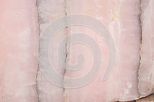 Lightened slices marble onyx. Horizontal image. Warm pink colors. Beautiful close up background