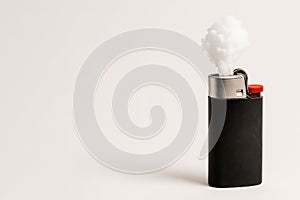 A lighter with a cloud of smoke instead of fire. Space for text.