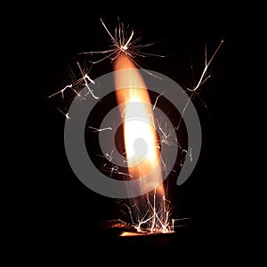 Lighter fire with sparks on black background