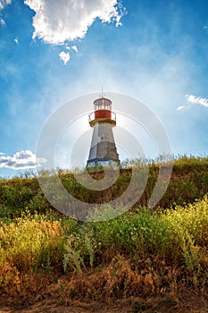 Lighthouse on background blue sky with cloud