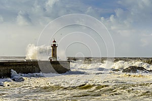 Lighthouse battered by huge waves on Atlantic Ocean