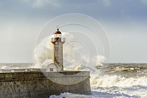 Lighthouse battered by huge waves on Atlantic Ocean