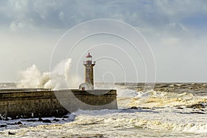 Lighthouse battered by huge waves on Atlantic Ocean