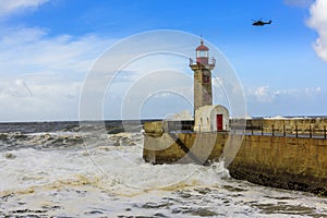 Lighthouse battered by huge waves on Atlantic Ocean