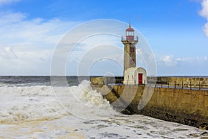 Lighthouse battered by huge waves on Atlantic Ocean