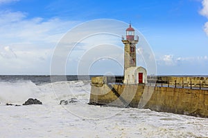 Lighthouse battered by huge waves on Atlantic Ocean