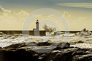 Lighthouse battered by huge waves on Atlantic Ocean