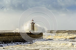 Lighthouse battered by huge waves on Atlantic Ocean