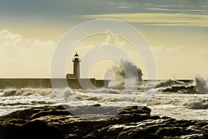 Lighthouse battered by huge waves on Atlantic Ocean